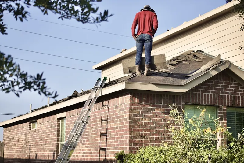 Professional roofer working on a residential roof in San Marcos